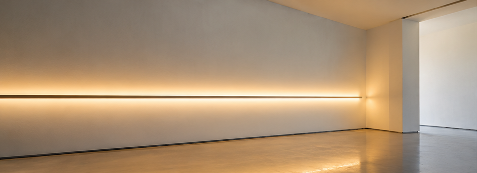 Minimal architectural interior with a horizontal warm-white light installation.